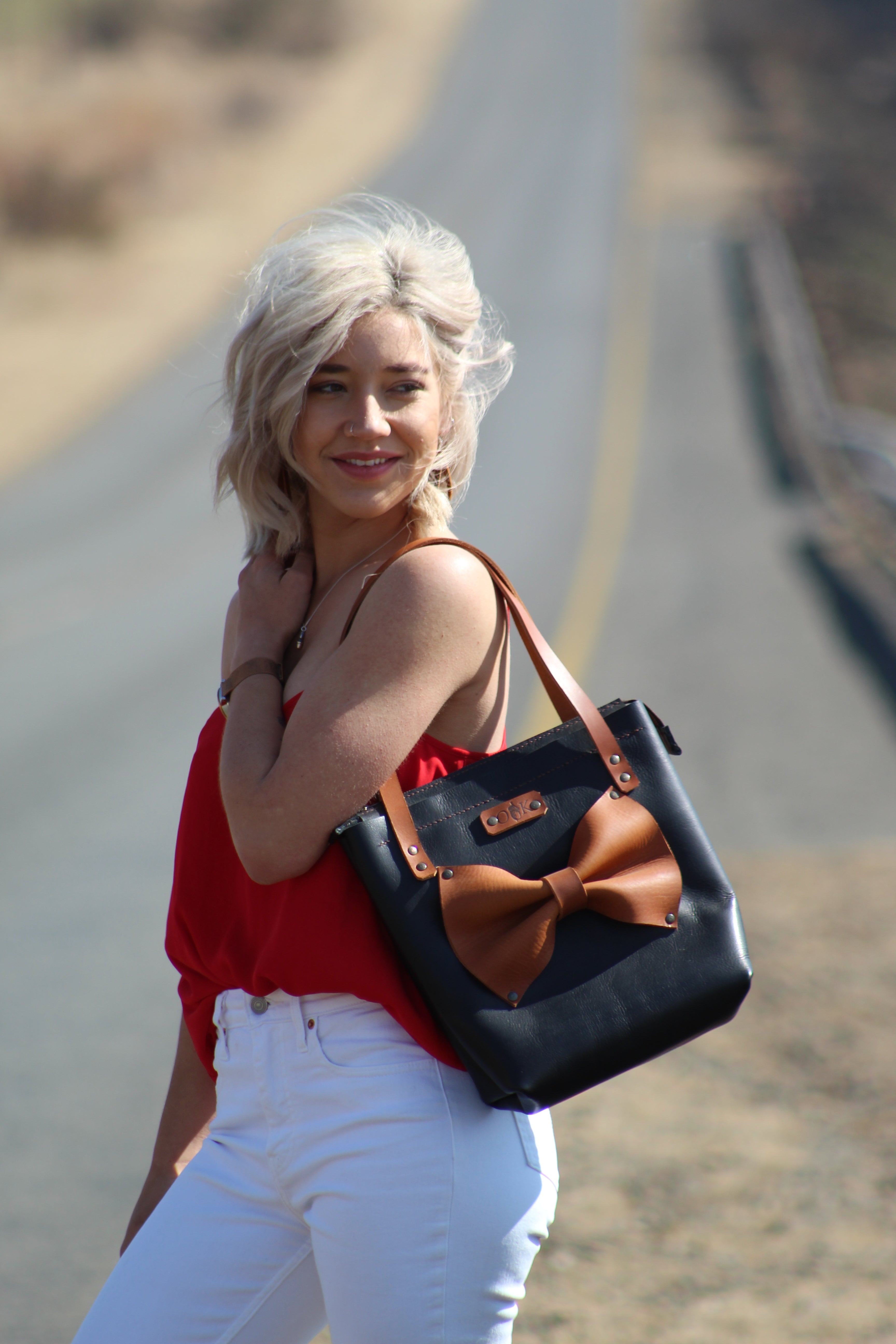 jani tote bag in black with tan bow and tan straps