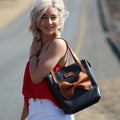 jani tote bag in black with tan bow and tan straps
